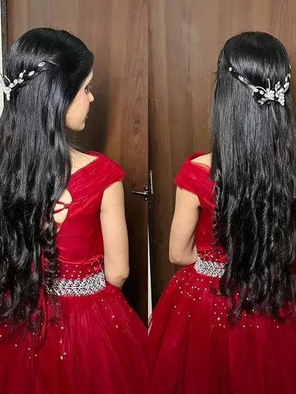The back view of the hairstyle for the red gown look, showing elegant waves and a delicate hair accessory.