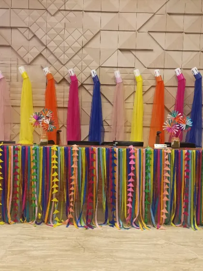 A colourful setup for a corporate Holi event. We decorated this table with multi-coloured ribbons and drapes, topped with pinwheels, to create a cheerful and festive awards or display area.