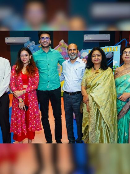 A group of family and friends posing for a photo, enjoying the celebration together.