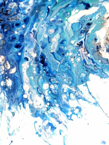 This detail shot shows the splash and spray of the wave, capturing a moment of intense energy.