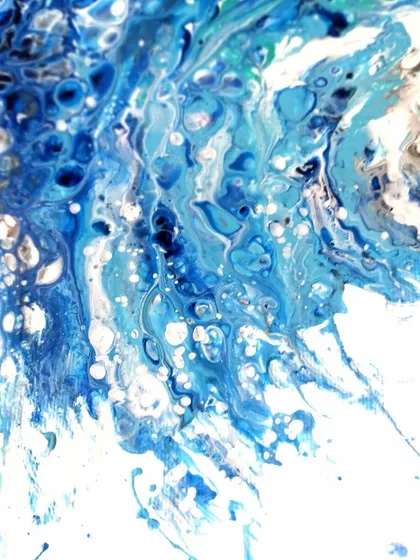 This detail shot shows the splash and spray of the wave, capturing a moment of intense energy.