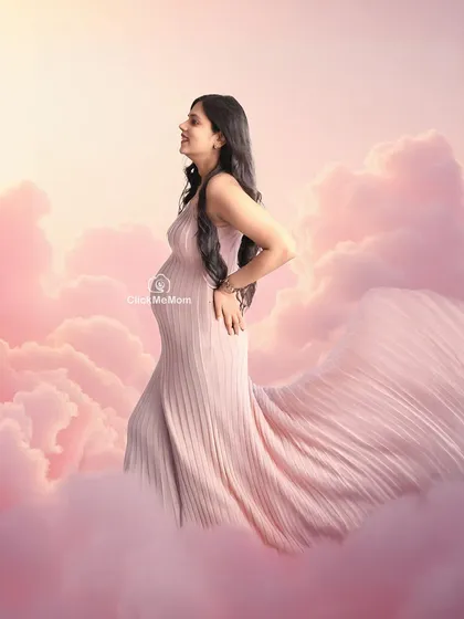 Floating on a cloud of dreams. This whimsical setup uses soft pink clouds and a flowing gown to create a heavenly, dreamlike maternity portrait. It’s a creative concept designed to capture the magical feeling of waiting for your little one to arrive.