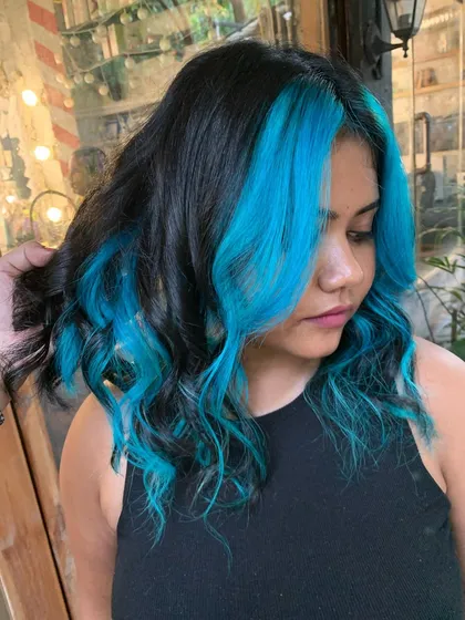 Another angle of the turquoise money piece, showing its vibrant color against the dark hair.