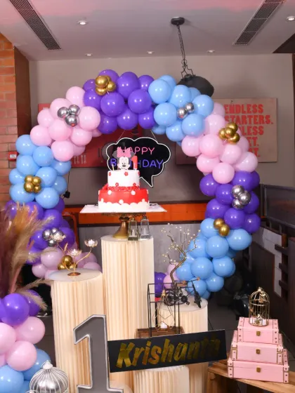 The Minnie Mouse cake takes center stage in this colorful first birthday decoration.