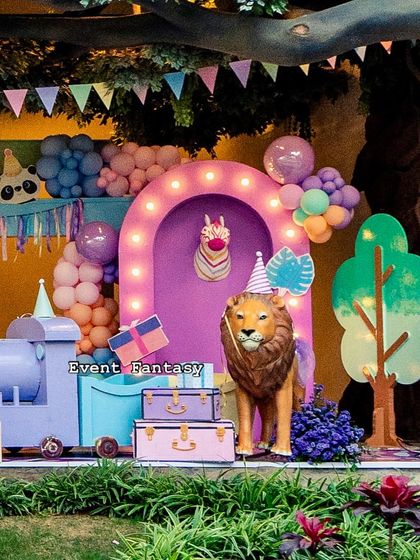 A whimsical "Party Animal" theme for Lishyan's birthday, featuring a pastel color palette, a friendly lion with a party hat, and a cute purple train.