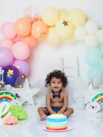 A full view of our 'Pastel Rainbow' theme, ready for the birthday boy. I style the entire set, from the balloon arch to the custom cake, creating a magical scene for your baby's one-year-old portraits.