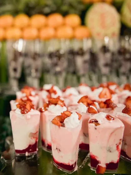 A refreshing dessert of fresh strawberries and cream served in individual glasses. This simple yet elegant dessert is a light and fruity option that's perfect for any celebration.