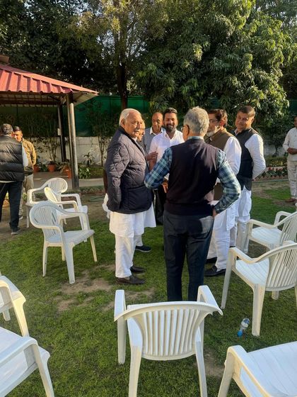 Engaging in a one-on-one conversation with former CM Bhupinder Singh Hooda. These personal interactions are vital for effective political advocacy.