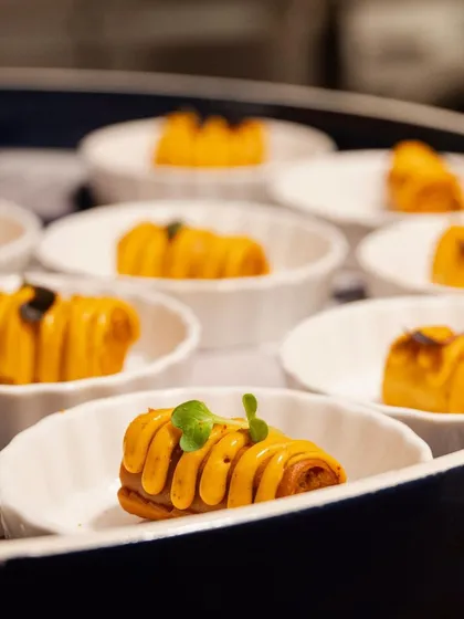A tray of our signature rolled canapés, showcasing intricate presentation and modern flavors, ready to be served to guests.