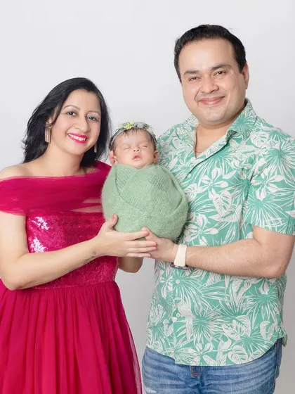 A slightly different pose, with the parents holding their newborn together. It symbolizes their new journey as a family.