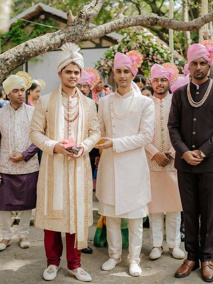 The groom and his groomsmen, all in elegant ethnic wear, wait for the bride's arrival.