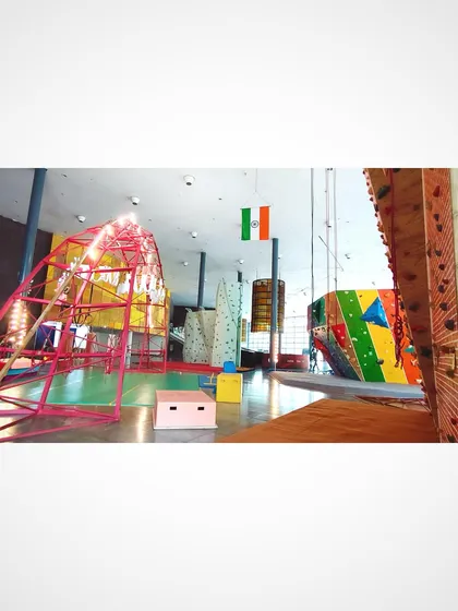 A panoramic view of the studio, highlighting the different zones for climbing and aerials, with the Indian flag hanging proudly.