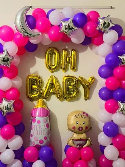 An "Oh Baby" balloon arch is a great way to celebrate a new arrival. For this home decoration, I used a vibrant mix of pink, purple, and white balloons, accented with star-shaped foils and baby-themed characters.