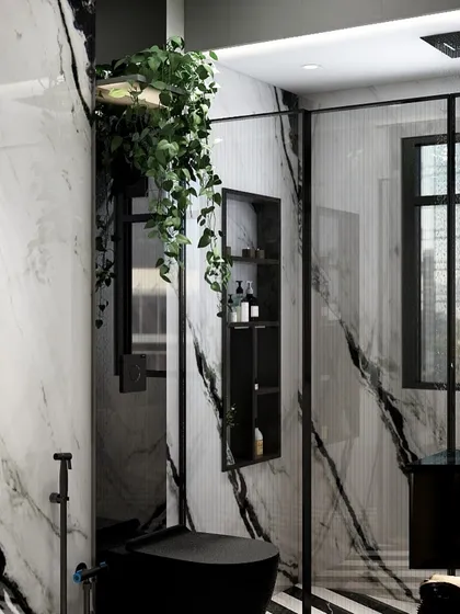 For this bathroom, we went for a bold, high-contrast look using dramatic panda white marble against black accents. The result is a space that feels like a private spa. The only pop of color comes from the greenery, which adds a touch of life and organic softness to the modern design.