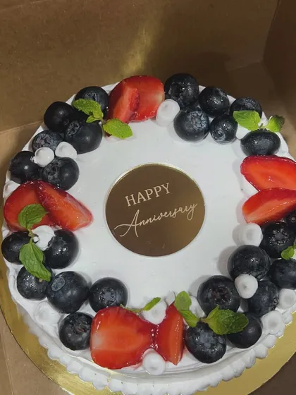 Sometimes the simplest cakes taste the best. This anniversary cake is topped with fresh blueberries and strawberries, a classic and delicious combination that never disappoints.