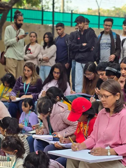 A diverse group of students watches an instructor's demonstration, highlighting that our workshops are open and welcoming to everyone.