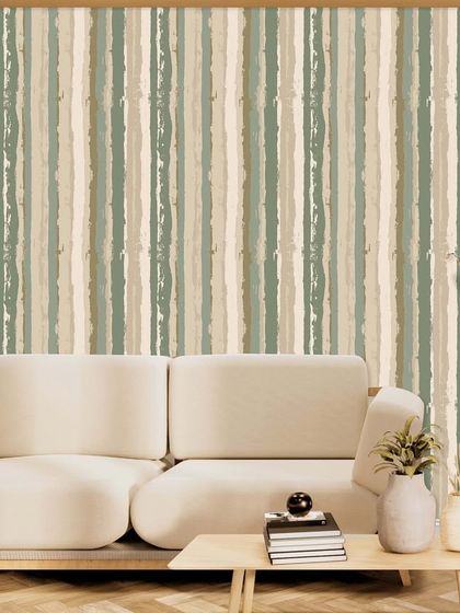 This design features vertical stripes with a painterly, textured effect in earthy green and beige tones. It adds a sense of height and subtle color to the room, pairing beautifully with the minimalist sofa.