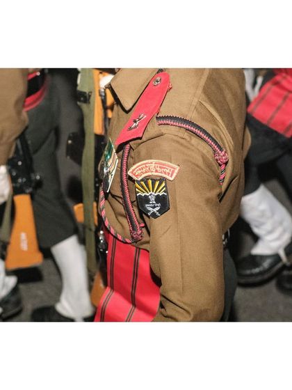 A detail shot of an Assam Rifles soldier's uniform, showing the badges and insignia.