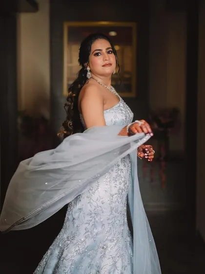 The bride's Sangeet look in motion. The flowing gown and elegant makeup create a dreamy, ethereal effect as she walks.