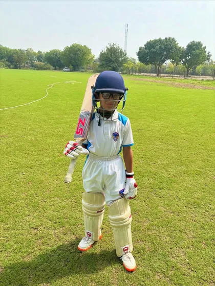 Cuteness plus commitment equals a future star. Our 8-year-old champ, fully padded and ready to play.