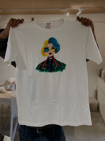 Don't just paint on canvas. Here, a participant shows off a cool, pop-art style portrait they painted on a plain white t-shirt.