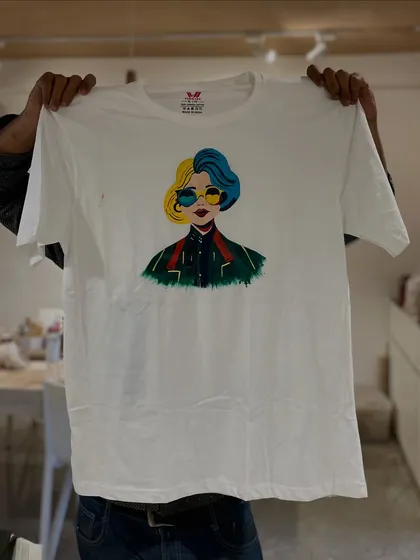 Don't just paint on canvas. Here, a participant shows off a cool, pop-art style portrait they painted on a plain white t-shirt.