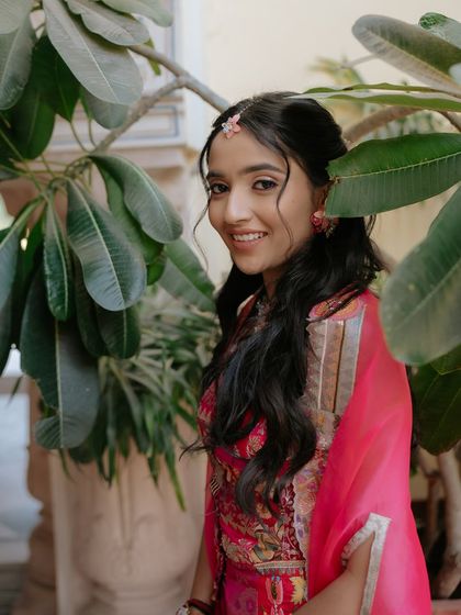 A happy, smiling portrait of the bride. The soft waves and minimal styling enhance her natural beauty.