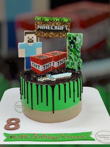 A Minecraft whip cream cake with a chocolate drip. This design includes Steve, a Creeper, and TNT blocks, capturing the essence of the popular game.