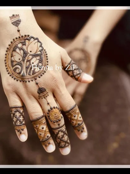 A beautiful back-hand design featuring a floral mandala. A delicate chain connects the mandala to the finger design, creating a look that is both traditional and modern, like hand jewelry.