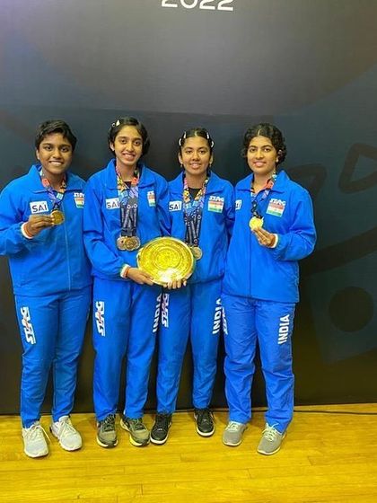 The victorious Indian team with their gold medals and team trophy.