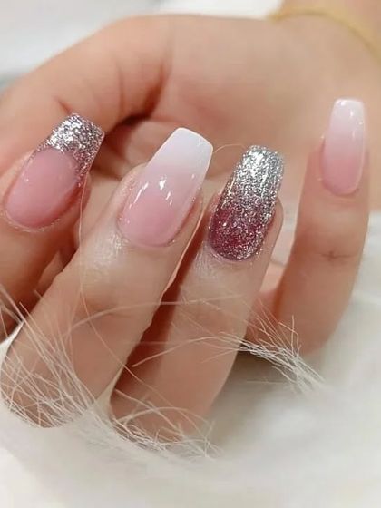 A classic ombre nail set with a twist, featuring silver and rose gold glitter accent nails.