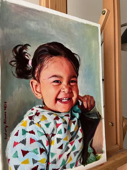 The finished portrait of my daughter on the easel, showing the final piece in a studio setting.