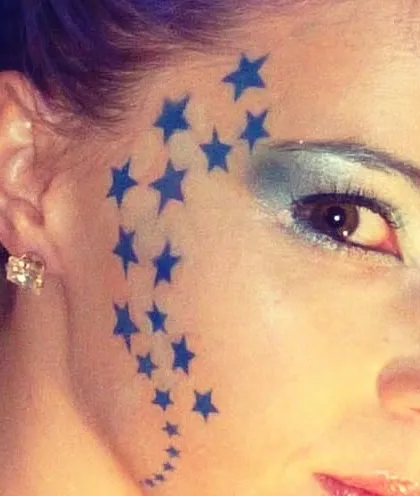 This is a great example of simple yet impactful face art. A cascade of blue stars along the temple creates a cool, edgy look that's popular with older kids and adults.