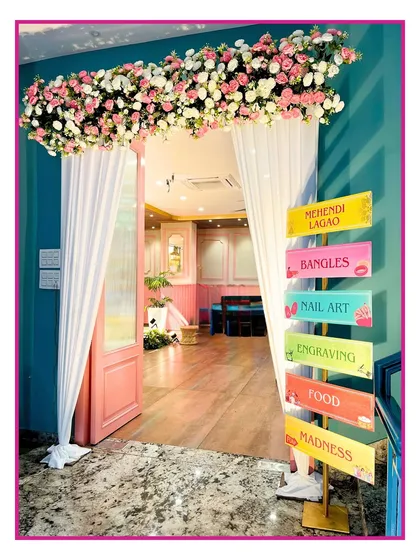 A colorful welcome to the Mehendi party. I created this fun directional signpost to guide guests to the different activities, including the bangle and nail art stalls.