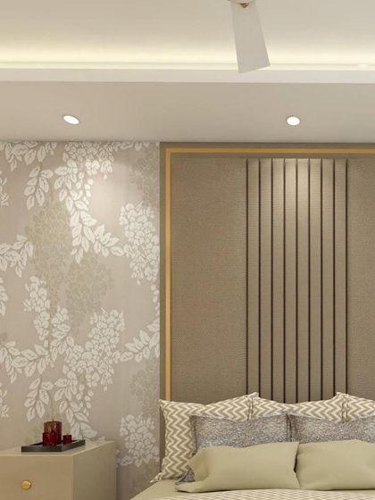 Another angle of the master bedroom, highlighting the combination of floral wallpaper and a beige upholstered headboard with fluted panel details. The design is a perfect blend of texture and pattern.