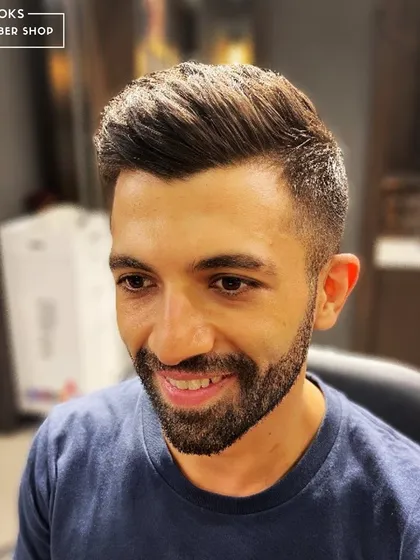 A great haircut makes for a great selfie. This client is all smiles after his fresh cut and style, ready for his close-up.