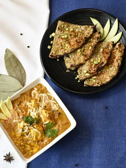 A symphony of flavors: our Paneer Mango Tikka is paired perfectly with a zesty Lasooni Kairi Paratha, combining sweet, tangy, and savory notes.
