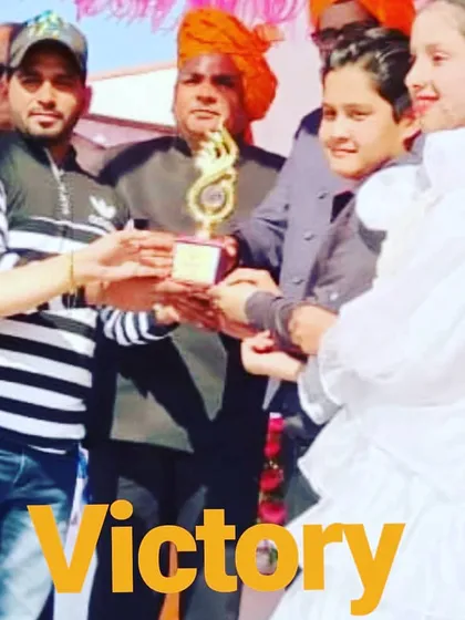 A snapshot of me and my students receiving a victory trophy at a performance event. These moments are a wonderful reward for all the hard work and practice the children put into their dance.