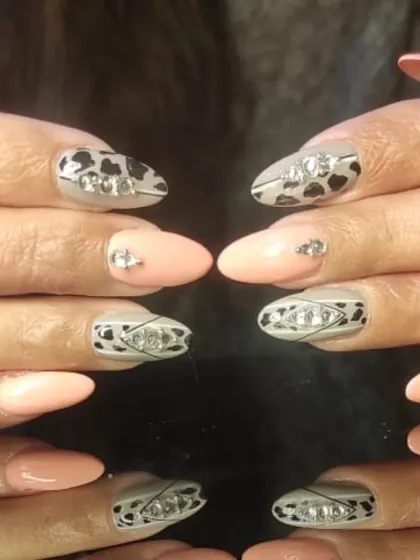 A unique design combining a nude base with animal print patterns and intricate 3D rhinestone arrangements.