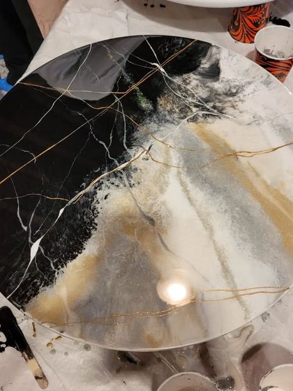 This is a finished marble resin tabletop from one of my workshops. The combination of black, white, and gold creates a luxurious and sophisticated look.