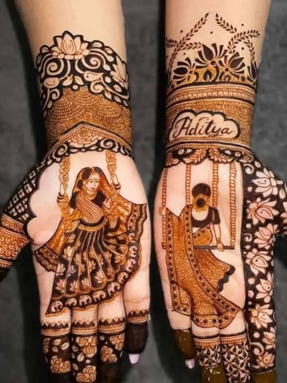 This charming design features figures of women on swings (jhoolas), with the groom's name "Aditya" written on the wrist, creating a playful and romantic theme.