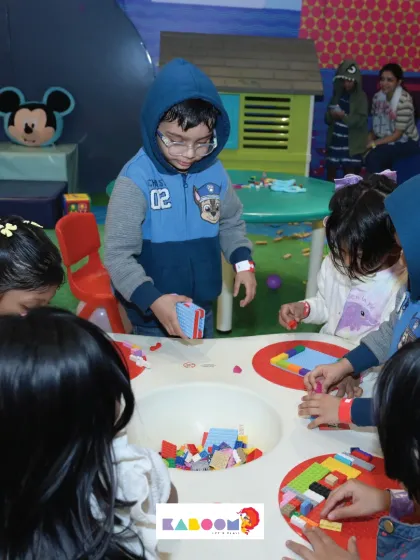 A table full of colorful blocks keeps these little ones busy and engaged in creative play.