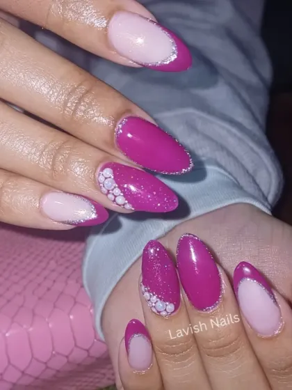 A vibrant magenta and pink French manicure with glitter and pearl dotwork on the accent nail.