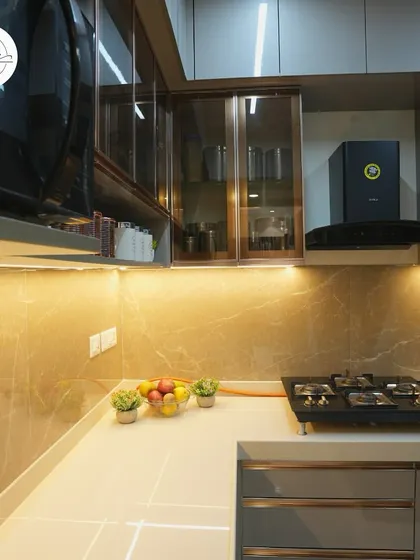The overhead cabinets with fluted glass provide stylish storage for dinnerware and glasses.