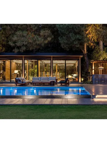The gym pavilion and pool area at night. The lighting design creates a resort-like feel, making the fitness and relaxation zones usable and beautiful at any hour.