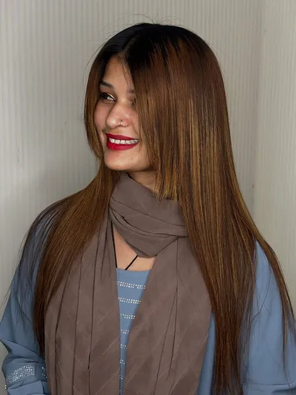 A smiling client enjoying her frizz free hair. Our treatments make hair so much easier to manage.