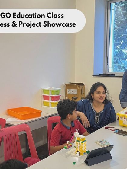 A parent and student share a moment of learning at our LEGO Education showcase at Vidyashilp Academy. We encourage parental involvement to support the child's STEM journey.