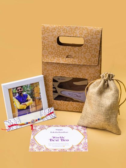 A classic Rakhi gift for a brother. This set includes a personalized photo frame, a 'World's Best Bro' card, a rakhi, and a rustic jute pouch for an earthy touch.