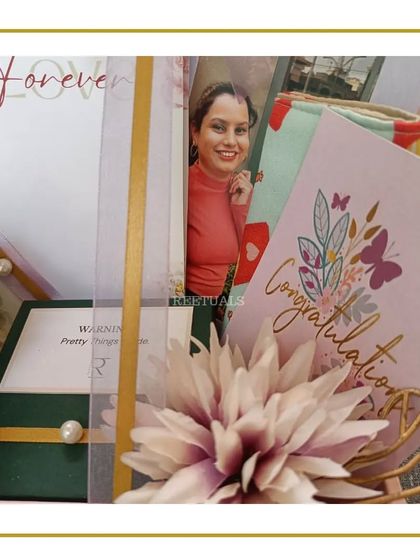 A close-up of the engagement hamper, showing the 'Congratulations' card and the happy photo of the bride-to-be.