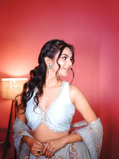 A close-up of the hairstyle and blouse, showing the versatility of the look.